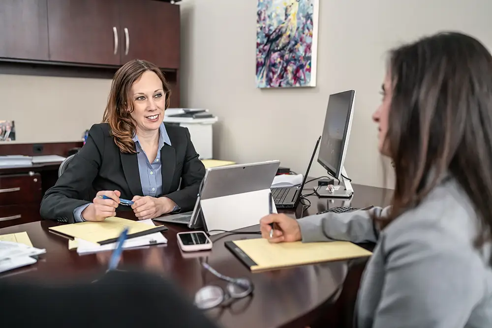 partner representing clients at desk